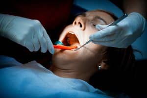 Dentists are expensive and can only see one person at a time. It’s difficult to avoid long wait times and to make an appointment with the right dentist. Contact Lee Family Dentistry for general dentistry treatments. Image of smiling woman patient getting a dental prodedure.