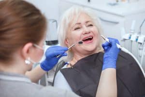 People need dental restoration for their overall well-being. Call or visit Lee Family Dentistry for restorative dentistry. Image of elderly woman getting a dental exam.